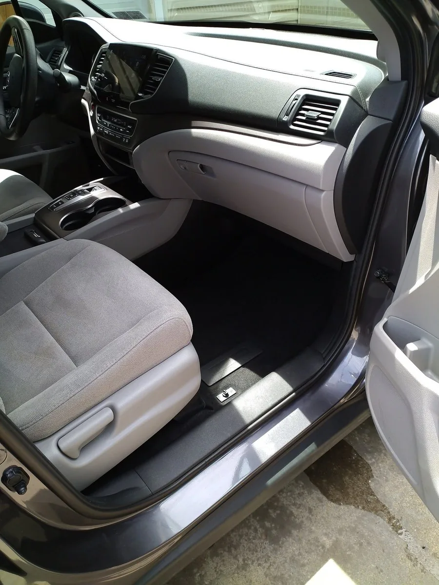 Professional interior detailing with freshly cleaned seats, console and dashboard